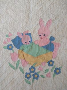 two rabbits in a basket with flowers on it