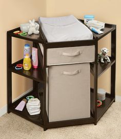 a baby crib with two storage bins on the bottom and one drawer open