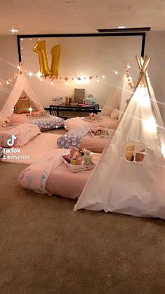 a teepee tent is set up in the middle of a room