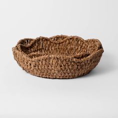 a brown woven basket on a white background