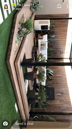 an overhead view of a living room with plants on the floor and green grass in the background