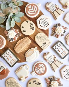 decorated cookies are displayed on a table with flowers and other decorative items in the background