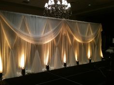 an image of a stage set up with chandelier and drapes on it