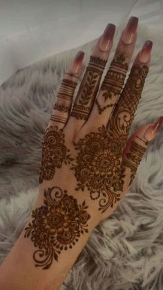 a woman's hand with hennap on it, showing the intricate design