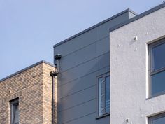 two windows on the side of a building