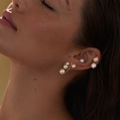 A decadent mix of our Pila Pearls and luscious round pearl ear jackets, this combination makes a bold and beautiful statement. Choose pink or white pearls, single or pair. Shown here with our Pearl Arc Earrings, Double Akoya Earrings, and Essential Pearl Stud (Large). ◆ Made to order, sold as singles. ◆ 14k solid yellow gold earring post & back◆ Freshwater Pearls (Studs): 4.5-5mm & 6-6.5mm ◆ Freshwater Pearls (Backs): 8-8.5mm ◆ Made in Los Angeles