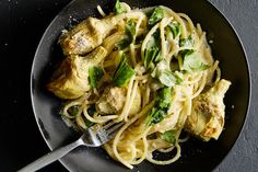 pasta with shrimp and asparagus in a skillet next to a pot of broccoli