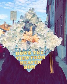 a graduate's cap with flowers on it and the words how's the view from heaven mom?