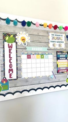 a bulletin board is decorated with colorful pom poms