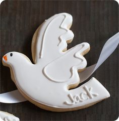 two decorated cookies with white icing on a table