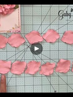 the video shows how to make pink paper flowers