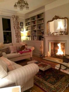 a living room filled with furniture and a fire place in the middle of a room