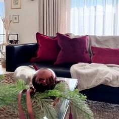 a living room filled with lots of furniture and christmas decorations on top of a coffee table