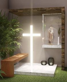 a white cross sitting in the middle of a room next to a plant and potted plants