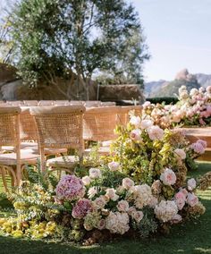 an outdoor ceremony setup with chairs and flowers