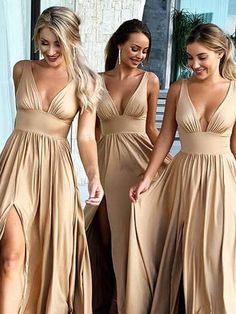 three beautiful women in long dresses walking together