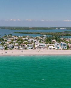 an aerial view of a beach with houses on it