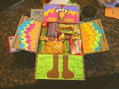 a box filled with candy and snacks sitting on top of a counter next to other boxes