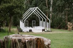 an outdoor wedding venue set up in the middle of a field with tables and chairs