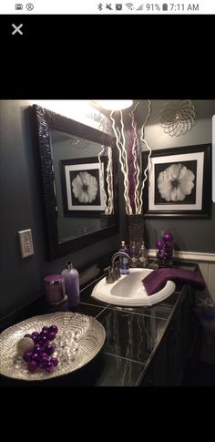 a bathroom with two sinks and pictures on the wall