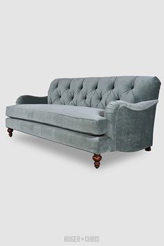 a gray couch sitting on top of a white floor