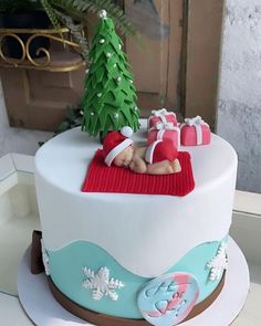 there is a christmas cake with decorations on the top, and a small tree in the middle