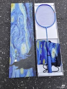 a tennis racket is laying on the ground next to a box with an image of van goghe