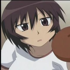 a person holding a brown object in front of their face and looking at the camera