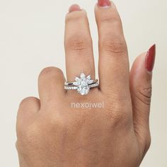 a woman's hand with a diamond ring on it