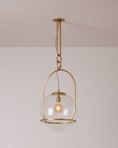 a light fixture hanging from the ceiling with a clear glass ball in front of it