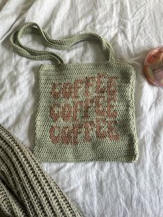 a crocheted purse sitting on top of a bed