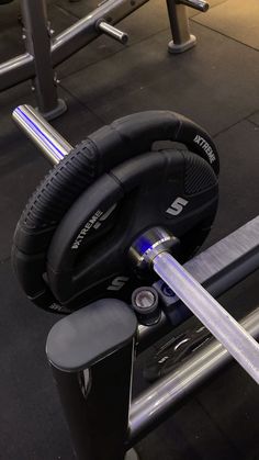 an exercise machine with headphones on the handlebars and bars in front of it