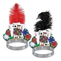 two tin canisters with playing cards on them and a red feather in the middle