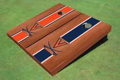 two wooden boards with blue, orange and white designs on them sitting on green grass