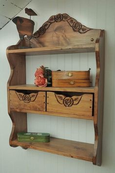 an old wooden shelf with drawers and other items on it's sides, against a white wall