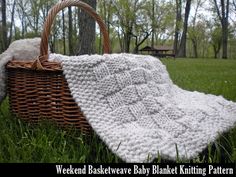 a basket and blanket sitting in the grass