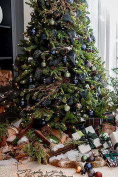 a christmas tree with presents under it