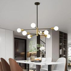 a dining room table with chairs and a chandelier hanging from the ceiling above it