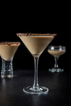 three martini glasses filled with an alcoholic drink