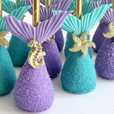 purple and blue desserts with gold decorations on them