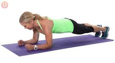 a woman doing push ups on a purple mat