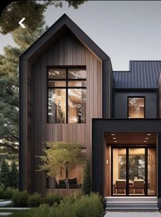 a modern house with two story windows and wood trimmings on the front door