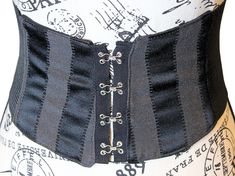 CHRISTMAS DELIVERY CUT OFF: DECEMBER 11, 2024 Please place your orders before this date to ensure delivery by Christmas. The VM Black Stripe Tapestry Waist Belt 💋This black tapestry renaissance belt is lined with either a 100% cotton canvas or broad cloth which is a cotton poly bend. The back of the gothic corset belt is a stretch, thick elastic that allows you to move and bend with ease while still snatching your waist and giving the illusion of wearing a corset. The goblincore underbust corse Black Gothic Corset Belt For Larp, Gothic Black Corset Belt For Larp, Black Medieval Corset Belt For Larp, Black Steampunk Corset Belt For Festival, Vintage Black Corset Belt For Costume Party, Black Medieval Underbust Corset Belt, Medieval Black Corset Belt For Festivals, Black Steampunk Corset Belt For Larp, Black Fitted Medieval Corset Belt