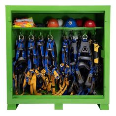 a green shelf filled with lots of different types of sports gear and equipment on display