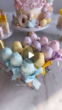 a table topped with cakes and cupcakes covered in frosting