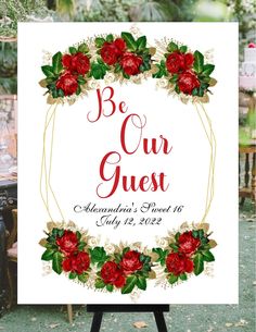 a sign that says be our guest with red flowers and greenery around the edges