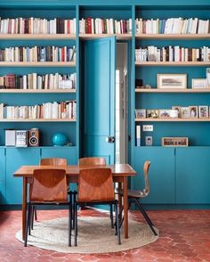 a living room filled with furniture and bookshelves