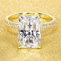 an engagement ring with a princess cut diamond in the center and pave diamonds around it