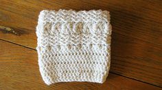 a white knitted dishcloth sitting on top of a wooden table