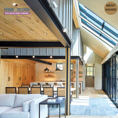 an open living room and dining area with skylights